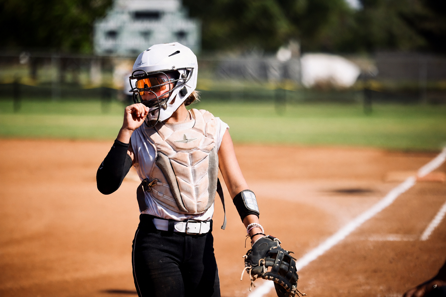 Macie Romano wearing catcher's gear on the softball field